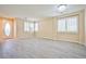 Bright living room with neutral paint, plank floors, and ample natural light at 7929 Palace Monaco Ave, Las Vegas, NV 89117