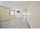 Spacious living room with plank floors, neutral walls, and easy access to other living areas at 7929 Palace Monaco Ave, Las Vegas, NV 89117
