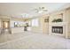 Open-concept living space with a fireplace, tile flooring and kitchen access at 7929 Palace Monaco Ave, Las Vegas, NV 89117
