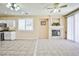 Open-concept living space showcasing a cozy fireplace and a view into the kitchen at 7929 Palace Monaco Ave, Las Vegas, NV 89117
