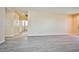 Bright living room featuring plank flooring with access to the home's tiled hallway at 7929 Palace Monaco Ave, Las Vegas, NV 89117