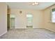 Light-filled primary bedroom offers tile flooring, a ceiling fan, and access to the ensuite bathroom at 7929 Palace Monaco Ave, Las Vegas, NV 89117
