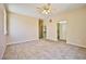 Large primary bedroom with tile flooring, a ceiling fan, and ensuite bathroom access at 7929 Palace Monaco Ave, Las Vegas, NV 89117