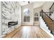 Spacious living room showcasing a marble accent wall with fireplace, high ceilings, and staircase at 8113 Bay Springs Dr, Las Vegas, NV 89128