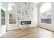 Bright living room with floor to ceiling fireplace and arched windows providing natural light at 8113 Bay Springs Dr, Las Vegas, NV 89128