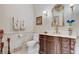 Charming powder room boasts a decorative mirror, wall sconces, and custom vanity at 8574 Verde Park Cir, Las Vegas, NV 89129