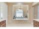 Opulent bathroom featuring a soaking tub, chandelier, and elegant fixtures at 8574 Verde Park Cir, Las Vegas, NV 89129