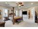 Primary bedroom featuring a four-post bed, carpet, and an en-suite bathroom at 8574 Verde Park Cir, Las Vegas, NV 89129