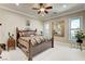 Warm bedroom featuring a wooden bed frame, plush carpet, and an ornate mirror at 8574 Verde Park Cir, Las Vegas, NV 89129