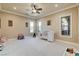 Bright bedroom featuring neutral walls, carpet, and a large window at 8574 Verde Park Cir, Las Vegas, NV 89129