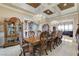 Formal dining room with large wood table, elegant chandelier, and views to the living room at 8574 Verde Park Cir, Las Vegas, NV 89129