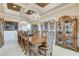 Formal dining room featuring an elegant chandelier, a large table, and seating for ten at 8574 Verde Park Cir, Las Vegas, NV 89129
