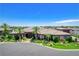 A beautiful front exterior of a well-maintained house with a circular driveway and mature palm trees at 8574 Verde Park Cir, Las Vegas, NV 89129