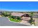 A high angle of the house, driveway and entrance gate and the mountains in the background at 8574 Verde Park Cir, Las Vegas, NV 89129
