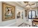 Elegant foyer with marble floors, art, and view into the dining room at 8574 Verde Park Cir, Las Vegas, NV 89129