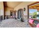Charming front porch with stone accents, wrought iron doors, and inviting seating at 8574 Verde Park Cir, Las Vegas, NV 89129