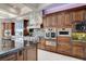 Gourmet kitchen featuring stainless steel appliances and custom cabinetry at 8574 Verde Park Cir, Las Vegas, NV 89129