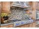 Gourmet kitchen featuring a professional range with a designer backsplash and ample counter space at 8574 Verde Park Cir, Las Vegas, NV 89129