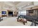 Spacious living room with a fireplace, large television, and a comfortable leather sofa at 8574 Verde Park Cir, Las Vegas, NV 89129