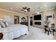 Spacious bedroom featuring a fireplace, ceiling fan, and refined decor at 8574 Verde Park Cir, Las Vegas, NV 89129
