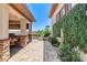 Cozy outdoor kitchen and patio area with a built-in grill, dining space, and fountain at 8574 Verde Park Cir, Las Vegas, NV 89129