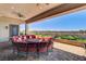Covered patio with a circular sofa set, perfect for outdoor entertaining with views of the well-manicured garden at 8574 Verde Park Cir, Las Vegas, NV 89129