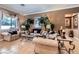 Spacious living room with neutral tones, tiled floors, and custom window treatments at 8698 Waterford Bend St, Las Vegas, NV 89123