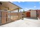 Backyard showing a shed with a door, a fence, greenery, and part of a pool at 8955 Ruby Moon Dr, Las Vegas, NV 89139