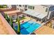 Aerial view of backyard featuring a modern pool, covered patio, a shed and privacy landscaping at 8955 Ruby Moon Dr, Las Vegas, NV 89139