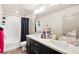Bathroom with double sinks, black vanity, shower/tub with curtain at 8955 Ruby Moon Dr, Las Vegas, NV 89139