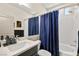 Bright bathroom featuring a shower-tub combo with a modern shower head and a navy shower curtain at 8955 Ruby Moon Dr, Las Vegas, NV 89139
