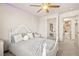Bedroom with gray bedding, ceiling fan, and an adjoining hallway at 8955 Ruby Moon Dr, Las Vegas, NV 89139