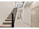 Inviting entryway featuring a staircase with a dark handrail and modern chandelier at 8955 Ruby Moon Dr, Las Vegas, NV 89139