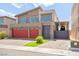 Contemporary home featuring a two-car garage, brick driveway and modern architectural design at 8955 Ruby Moon Dr, Las Vegas, NV 89139