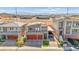 Modern home exterior with a three-car garage and well-maintained landscaping at 8955 Ruby Moon Dr, Las Vegas, NV 89139