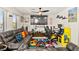 Vibrant game room featuring a colorful rug, Pac-Personal arcade, and plush seating at 8955 Ruby Moon Dr, Las Vegas, NV 89139