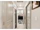 Hallway with gray walls and white trim that leads to a room with black and white marble floors at 8955 Ruby Moon Dr, Las Vegas, NV 89139