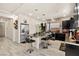 This modern kitchen features dark cabinets, a granite island with barstool seating, and stainless steel appliances at 8955 Ruby Moon Dr, Las Vegas, NV 89139