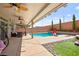 Relaxing covered patio with comfortable seating overlooking the refreshing backyard pool at 8955 Ruby Moon Dr, Las Vegas, NV 89139