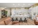Bright kitchen features a large center island with seating, white cabinets and modern appliances at 964 Edinburgh Fields Ct, Las Vegas, NV 89138