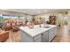 Open-concept kitchen with white countertops, a center island, and a view of the outdoor living space at 964 Edinburgh Fields Ct, Las Vegas, NV 89138