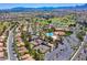 Aerial view of community tennis courts and pool with mature trees at 9912 Woodhouse Dr, Las Vegas, NV 89134