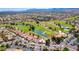 Aerial view showcasing the community golf course, mature trees and desert landscaping at 9912 Woodhouse Dr, Las Vegas, NV 89134