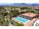 Community pool with a water feature surrounded by chairs and umbrellas at 9912 Woodhouse Dr, Las Vegas, NV 89134