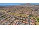 Aerial view showcasing the community layout, golf course, and surrounding mountains at 9912 Woodhouse Dr, Las Vegas, NV 89134
