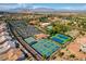 Aerial view of tennis courts and community pool in the neighborhood at 9912 Woodhouse Dr, Las Vegas, NV 89134
