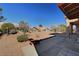 Expansive backyard featuring desert landscaping, mature trees, and a covered patio, great for outdoor relaxation at 9912 Woodhouse Dr, Las Vegas, NV 89134