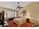 Vaulted bedroom with shutters, ceiling fan and an ensuite bathroom at 9912 Woodhouse Dr, Las Vegas, NV 89134