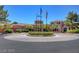 Attractive clubhouse with well-maintained landscaping and flags in a circular driveway at 9912 Woodhouse Dr, Las Vegas, NV 89134