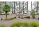 Well-maintained community center signage with lush landscaping and rock features at 9912 Woodhouse Dr, Las Vegas, NV 89134